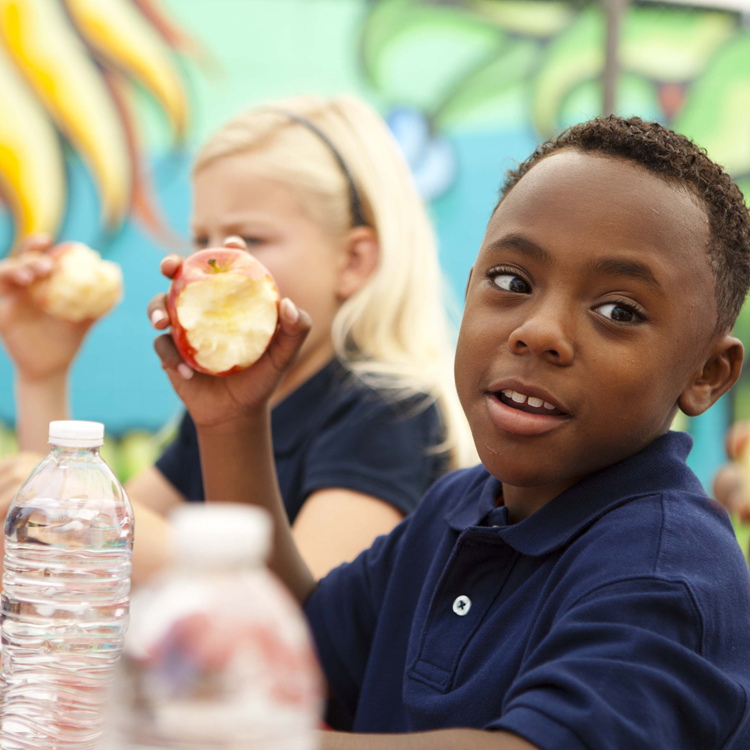 Kids at school eating outside.