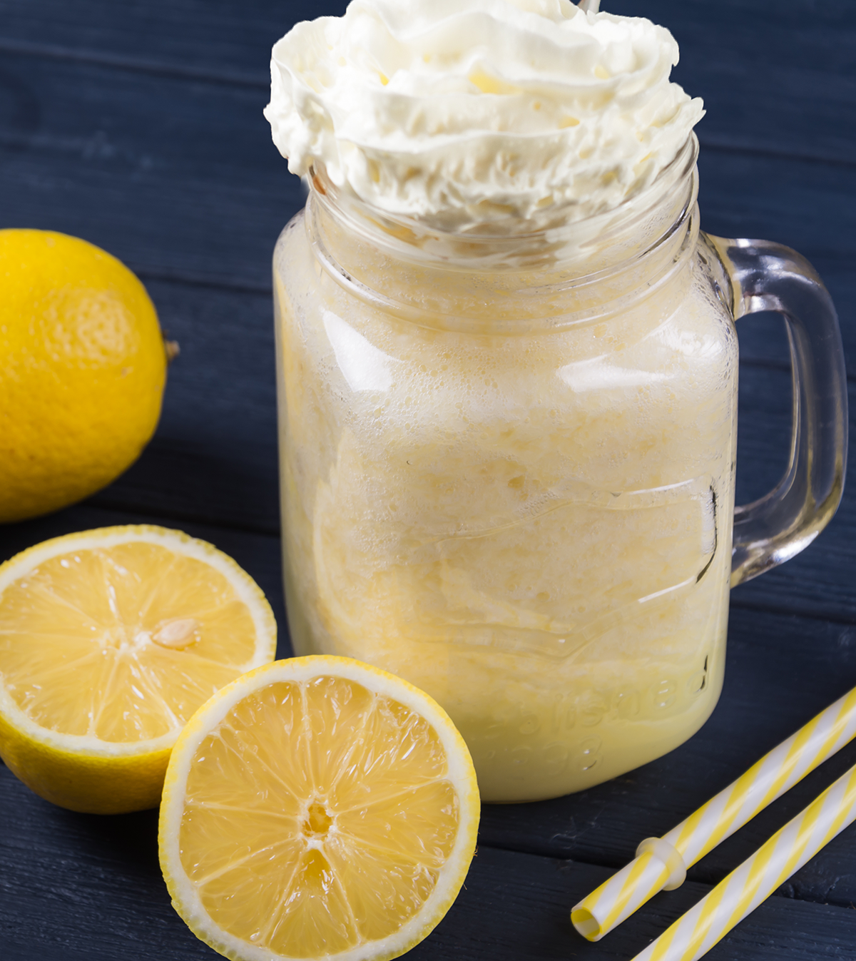 Mason jar filled with frozen lemonade and whipped cream.